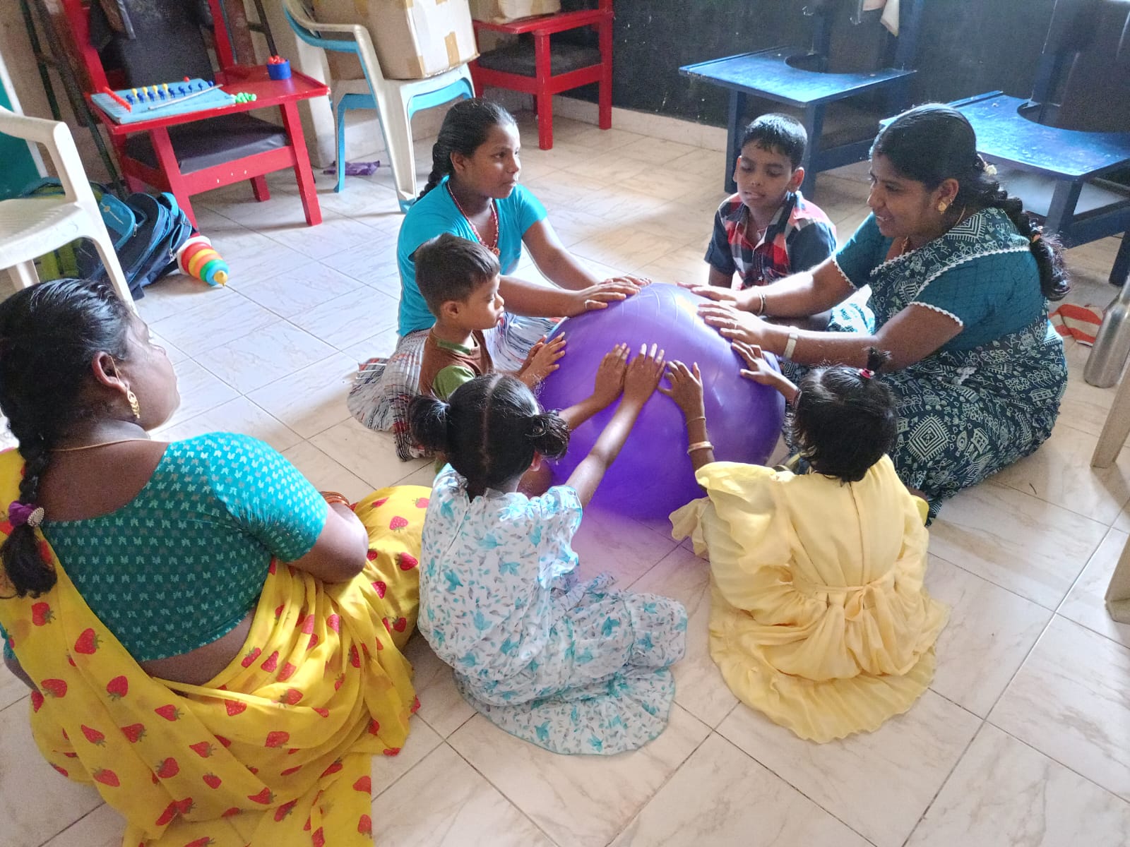 A joyful moment with children and caregivers at Manolayam